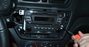 Unscrew the screws that are holding the radio on the dashboard