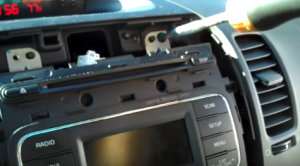 Unscrew the screws that are holding the radio on the dashboard