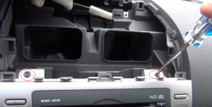 Remove two last screws that are holding the radio with a screwdriver