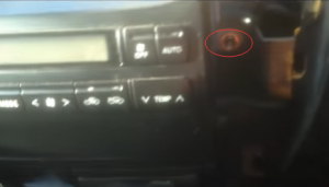 There are four screws holding the radio on the dashboard. Remove them with a screwdriver
