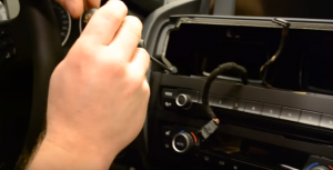 Use a screwdriver to remove the screws that fix the radio panel