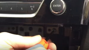 Unscrew the screws holding the radio with a screwdriver